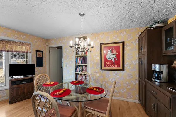 a view of a dining room with furniture and wooden floor