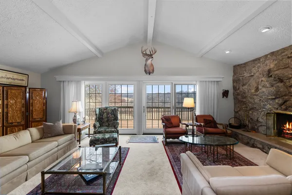 a living room with furniture large window and flat screen tv