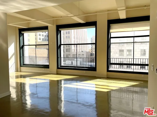 a view of spacious bathroom with a tub and large windows
