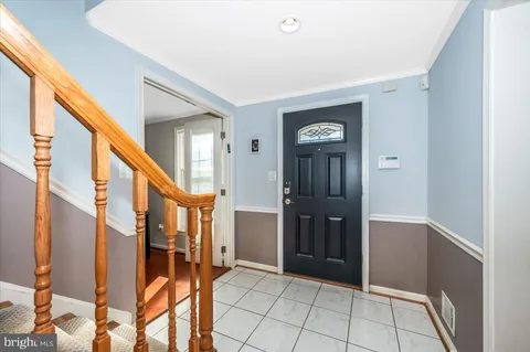 a view of an entryway with wooden floor