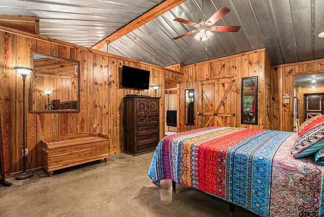 a bed room with a bed and a ceiling fan