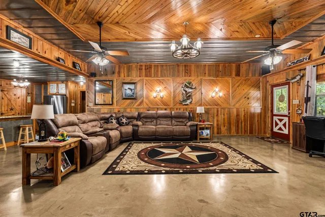 a room with lots of furniture and chandelier