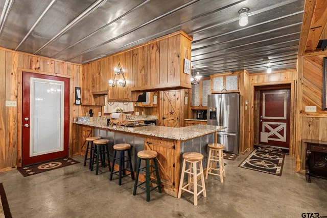 a kitchen with appliances a sink and cabinets