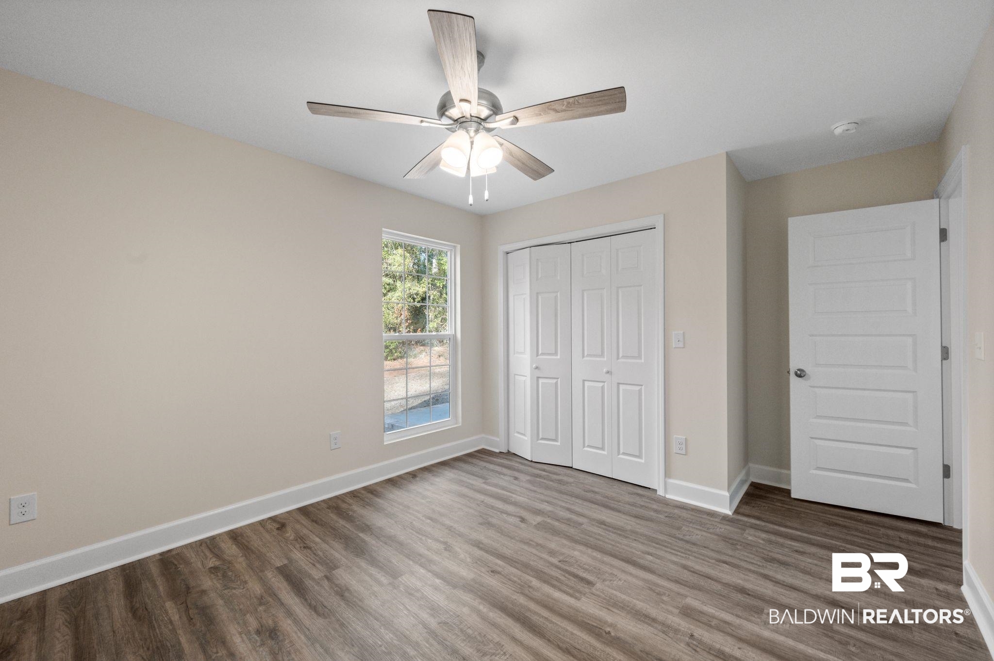1473 Pollard Road Daphne, AL 36526 - Photo 25 of 32 Unfurnished bedroom with hardwood / wood-style flooring, a closet, and ceiling fan