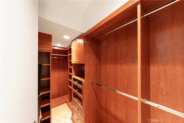 a bedroom with a bed and a potted plant