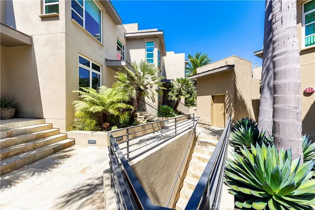 a view of a house with pool and sitting area