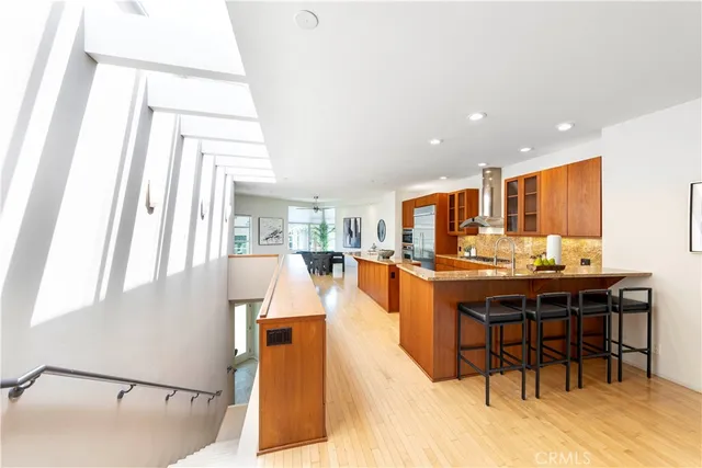a living room with stainless steel appliances kitchen island granite countertop furniture and a kitchen view