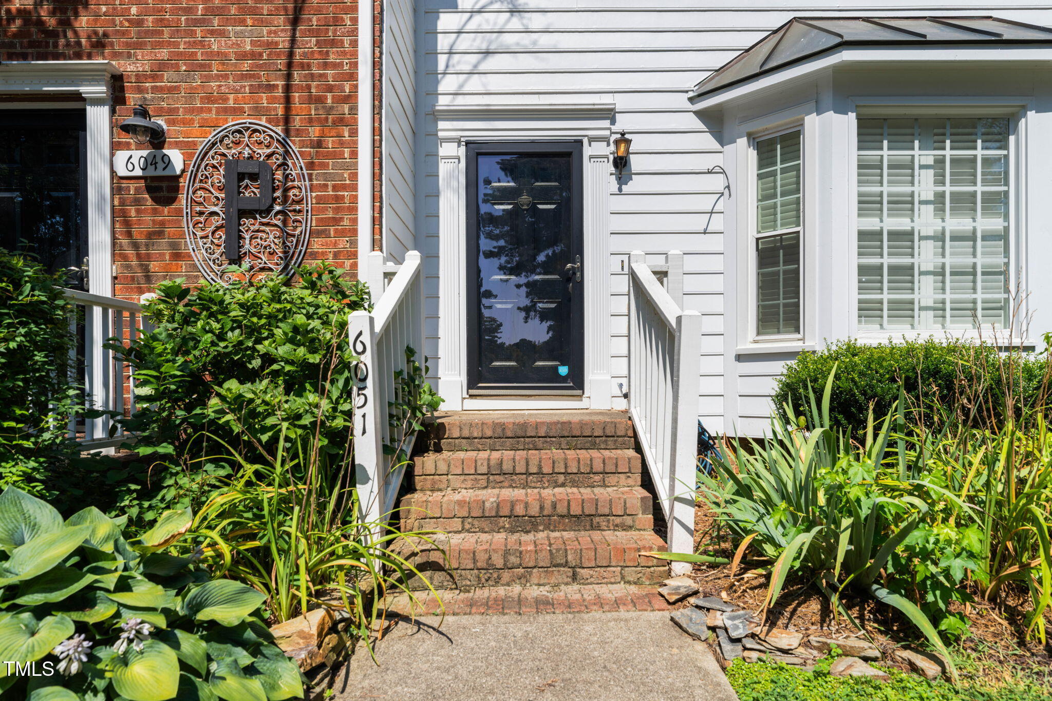 6051 Epping Forest Drive Raleigh, NC 27613 - Photo 11 of 26 a front view of a house with a yard