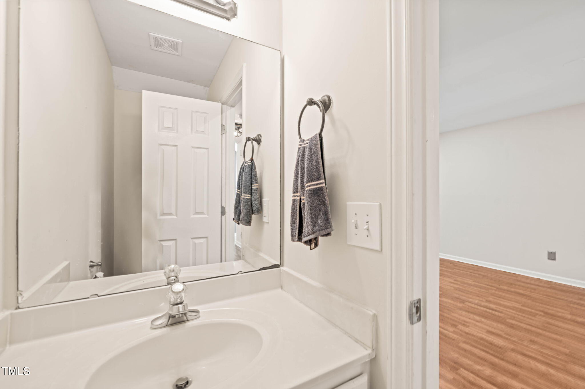 6051 Epping Forest Drive Raleigh, NC 27613 - Photo 18 of 26 a bathroom with a sink and a mirror