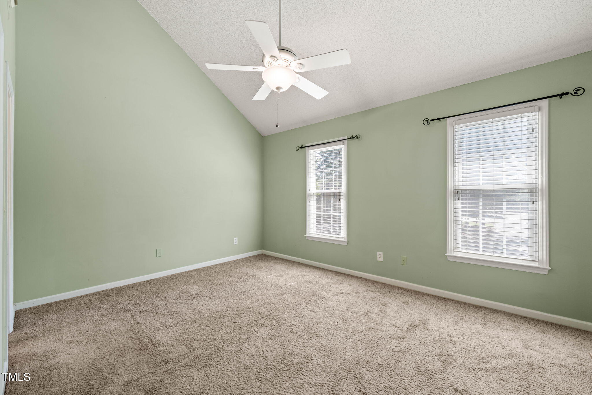 6051 Epping Forest Drive Raleigh, NC 27613 - Photo 19 of 26 an empty room with windows and fan