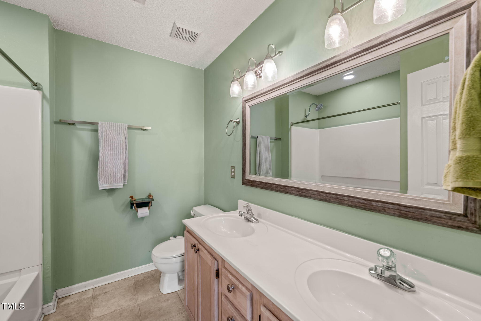 6051 Epping Forest Drive Raleigh, NC 27613 - Photo 23 of 26 a bathroom with a sink and a mirror