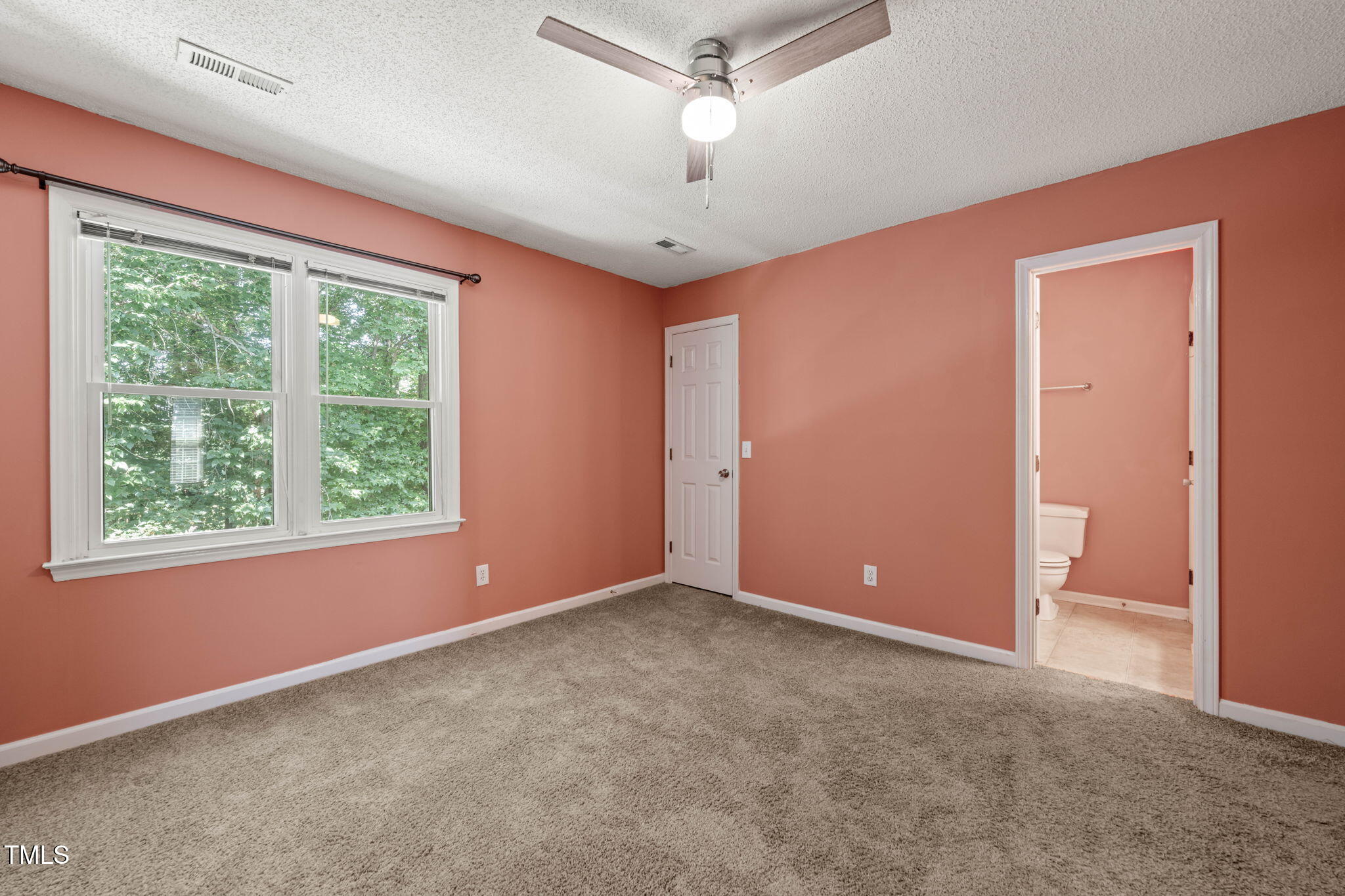 6051 Epping Forest Drive Raleigh, NC 27613 - Photo 24 of 26 an empty room with windows and ceiling fan
