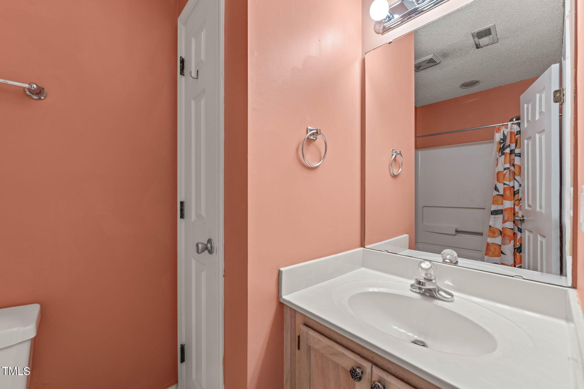 6051 Epping Forest Drive Raleigh, NC 27613 - Photo 26 of 26 a bathroom with a sink and a mirror