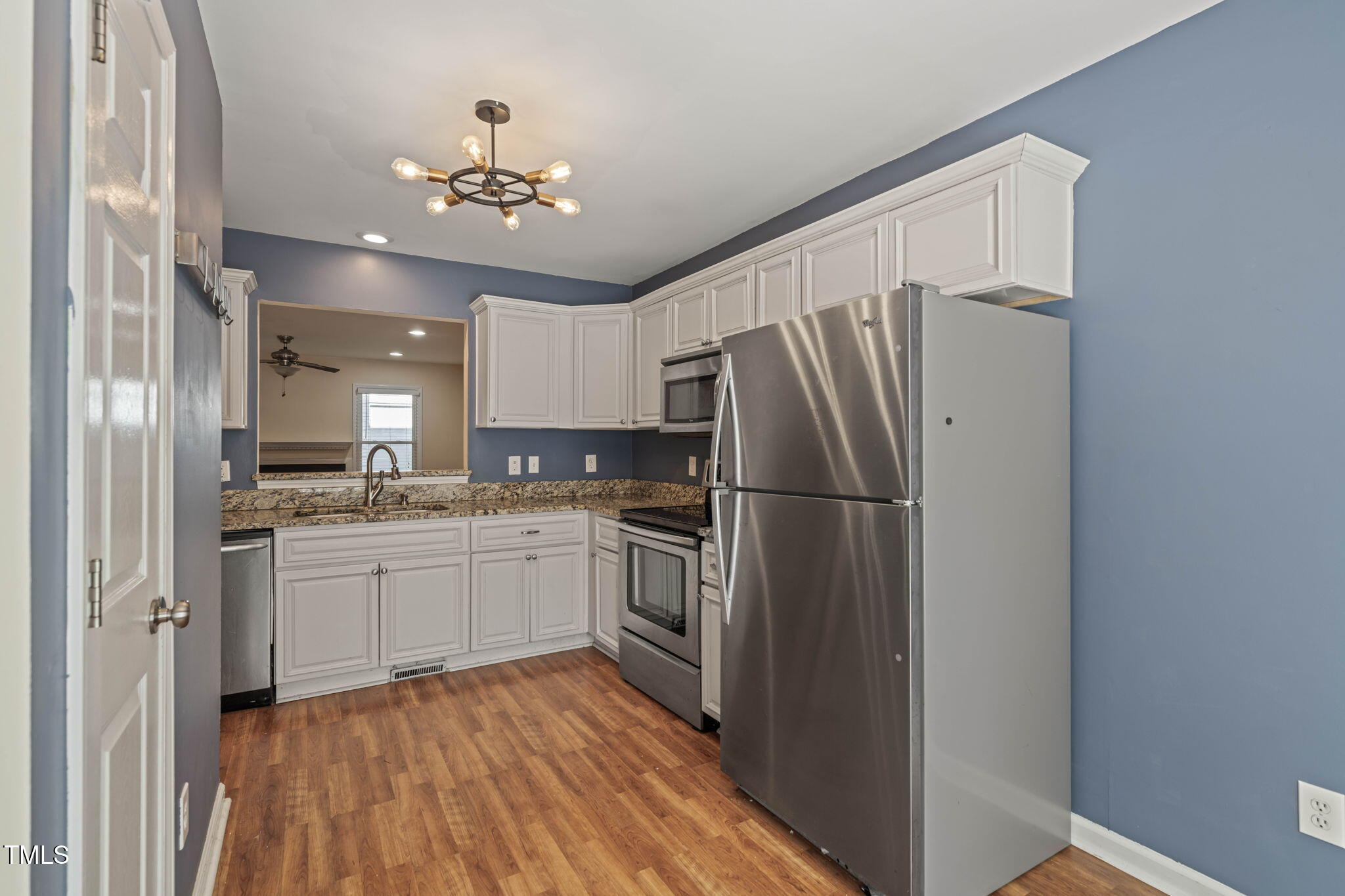 6051 Epping Forest Drive Raleigh, NC 27613 - Photo 6 of 26 a kitchen with a refrigerator sink and cabinets