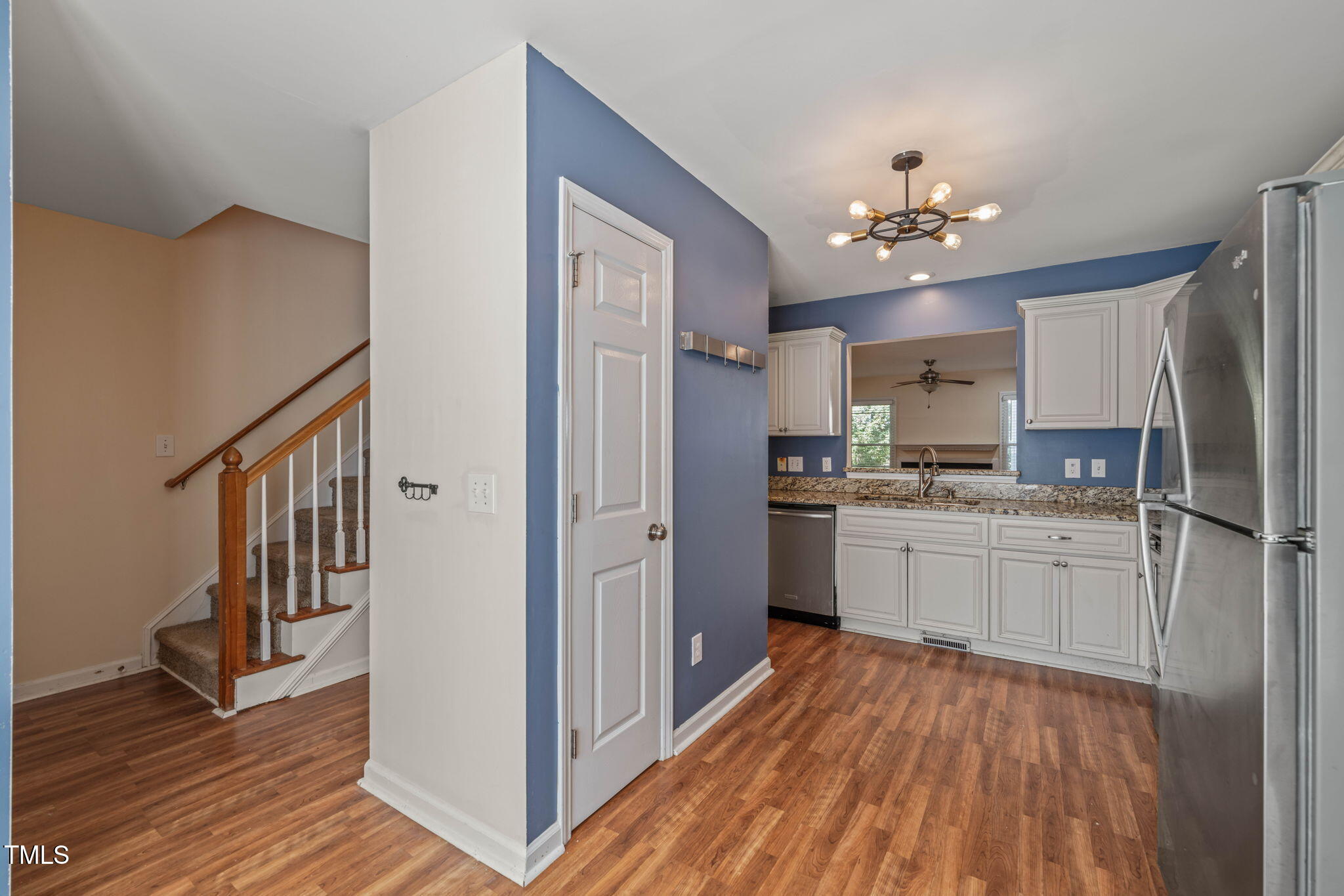 6051 Epping Forest Drive Raleigh, NC 27613 - Photo 7 of 26 a kitchen with a refrigerator and a stove top oven