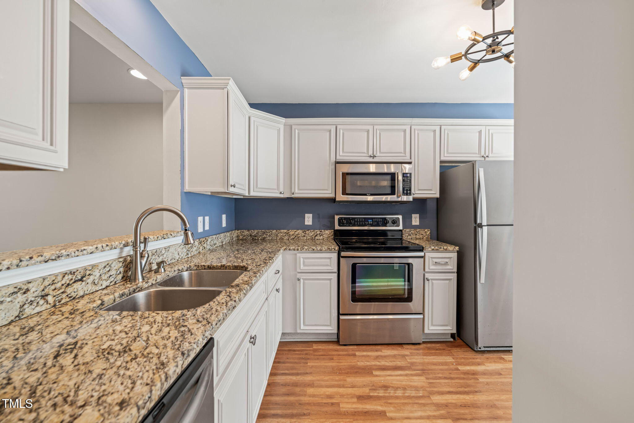 6051 Epping Forest Drive Raleigh, NC 27613 - Photo 8 of 26 a kitchen with a sink stove and refrigerator