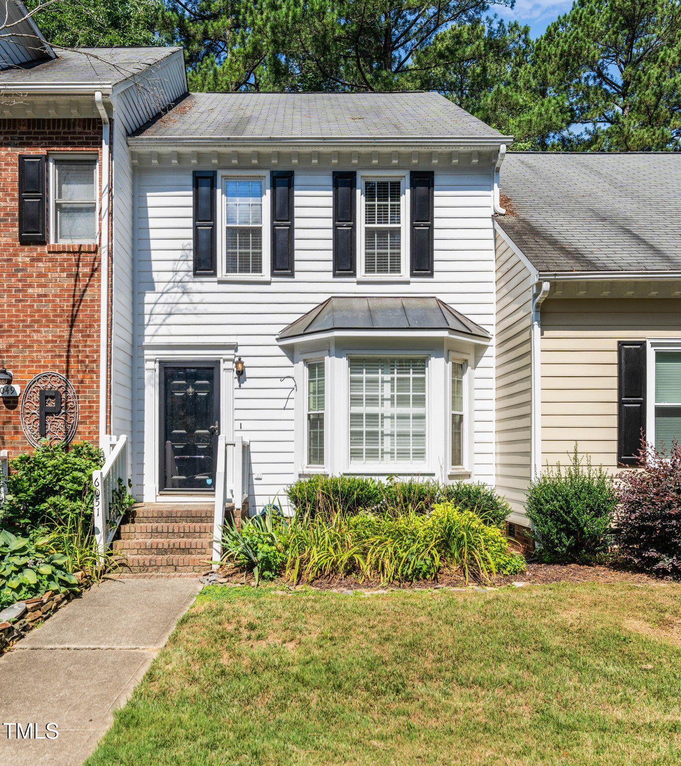 6051 Epping Forest Drive Raleigh, NC 27613 - Photo 10 of 26 a front view of a house with a yard