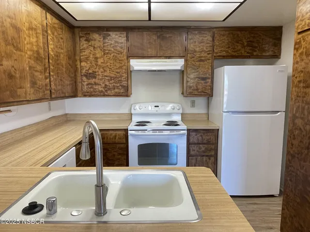 a kitchen with a refrigerator and a sink