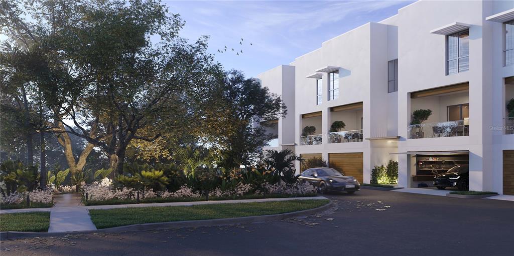 1028 Sunset Point Road, Unit R4 Clearwater, FL 33755 - Photo 2 of 12 a front view of a house with a garden and yard