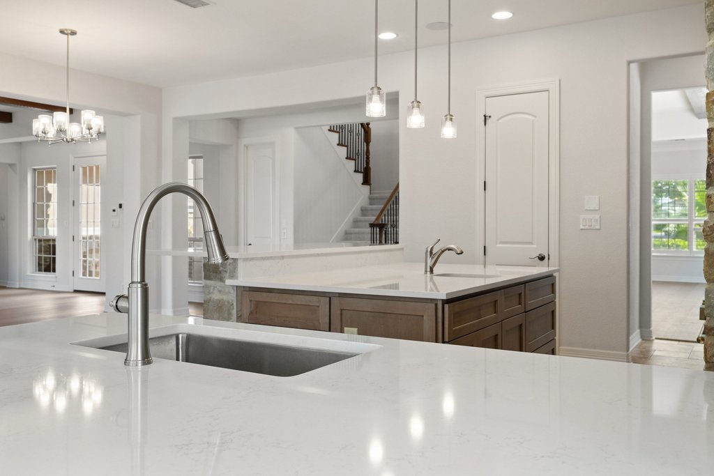 109 Largo Cove Austin, TX 78734 - Photo 12 of 40 Granite counters and stainless steel appliances elevate this open-concept kitchen with a seamless flow to living areas.