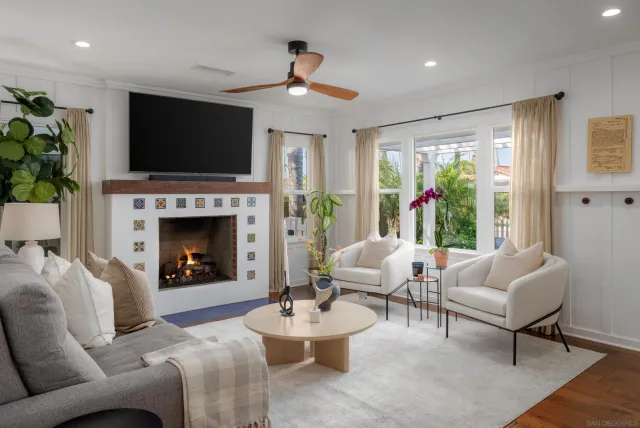 a living room with furniture a flat screen tv and a fireplace