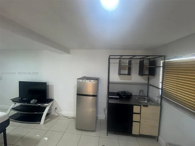 a kitchen with a refrigerator and a stove