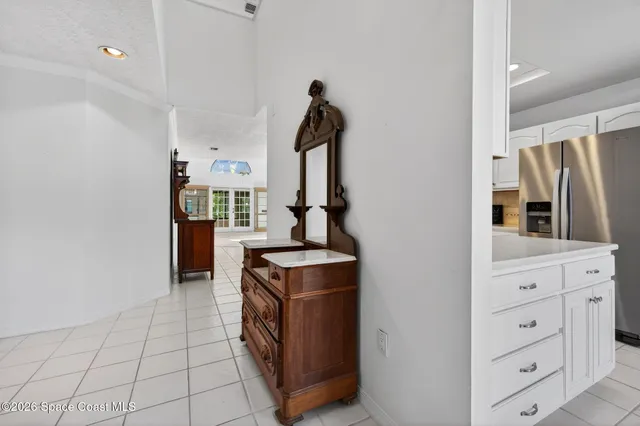 a kitchen with stainless steel appliances granite countertop a sink a stove a refrigerator and cabinets