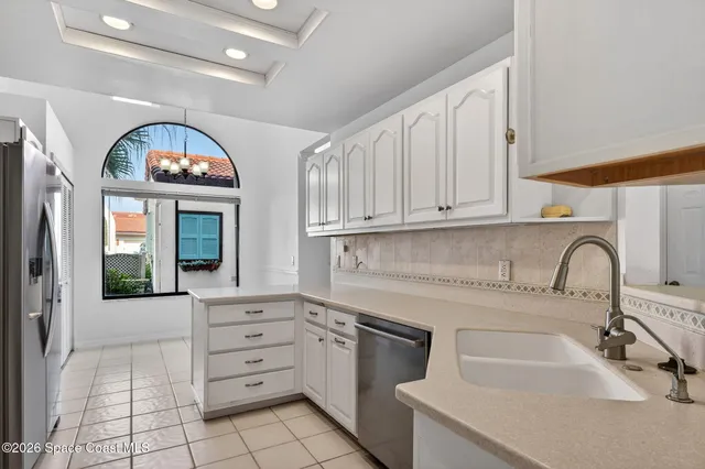a view of a room with a large window and chandelier