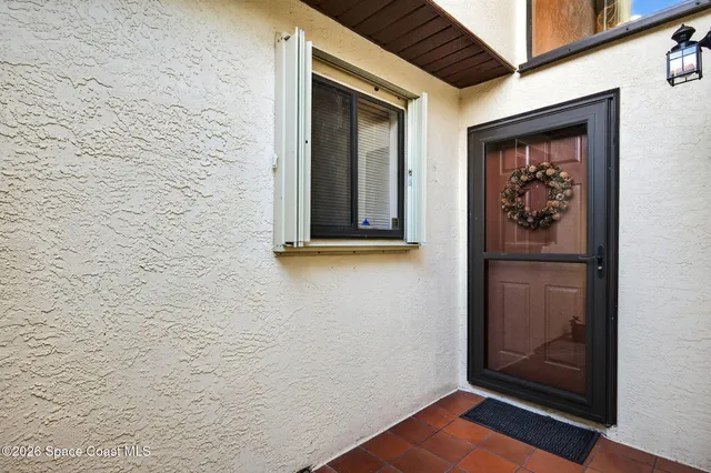 a view of front door and potted plants