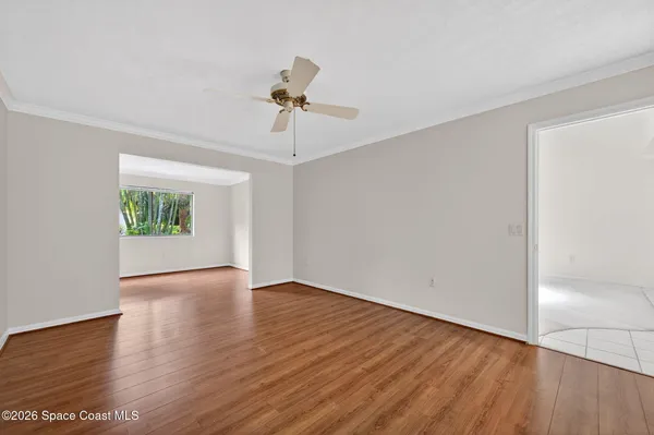an empty room with white cabinet and mirrors