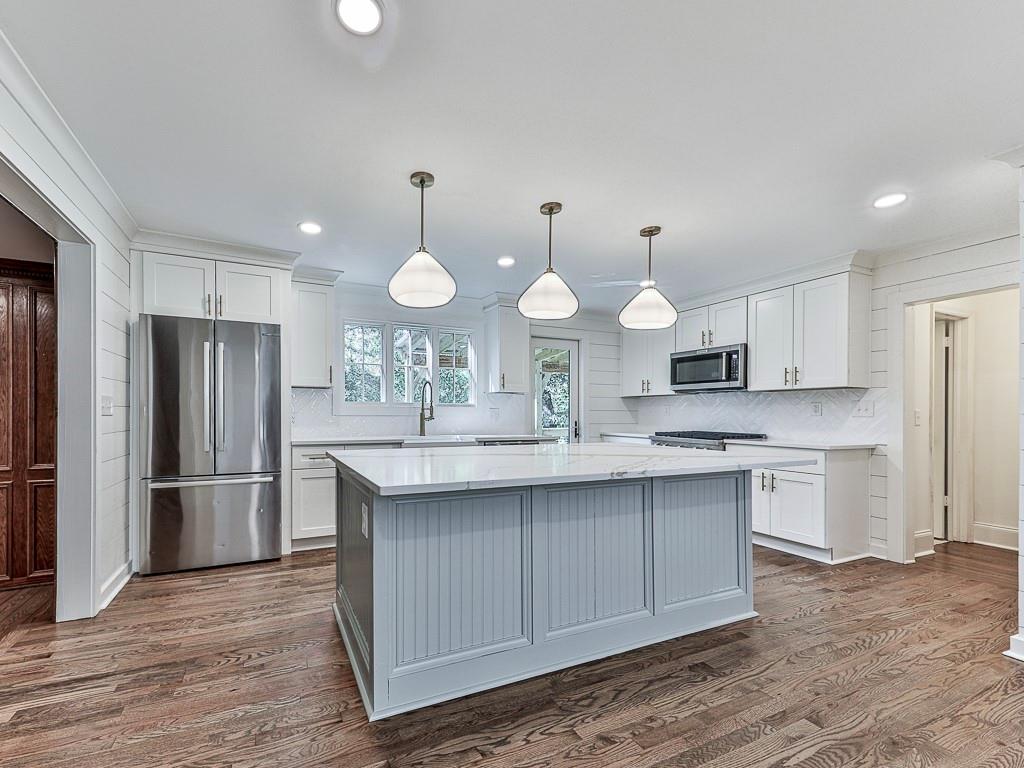 633 Butterworth Road Canton, GA 30114 - Photo 8 of 55 a kitchen with stainless steel appliances a sink cabinets and wooden floor