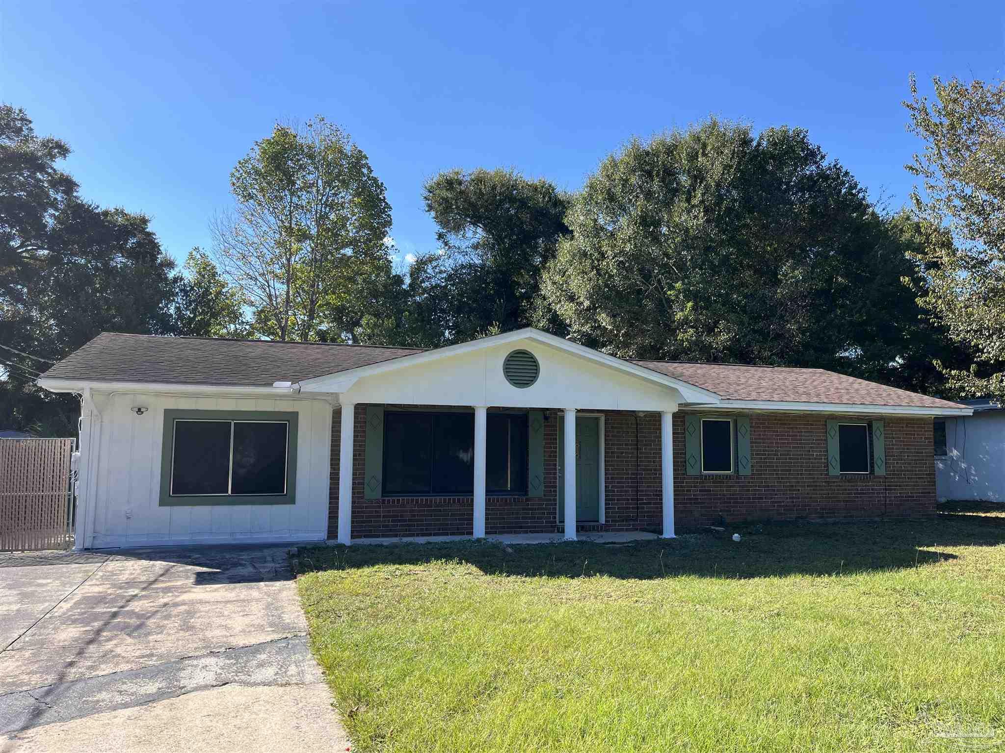4511 St Nazaire Road Pensacola, FL 32505 - Photo 1 of 21 a front view of a house with yard and porch