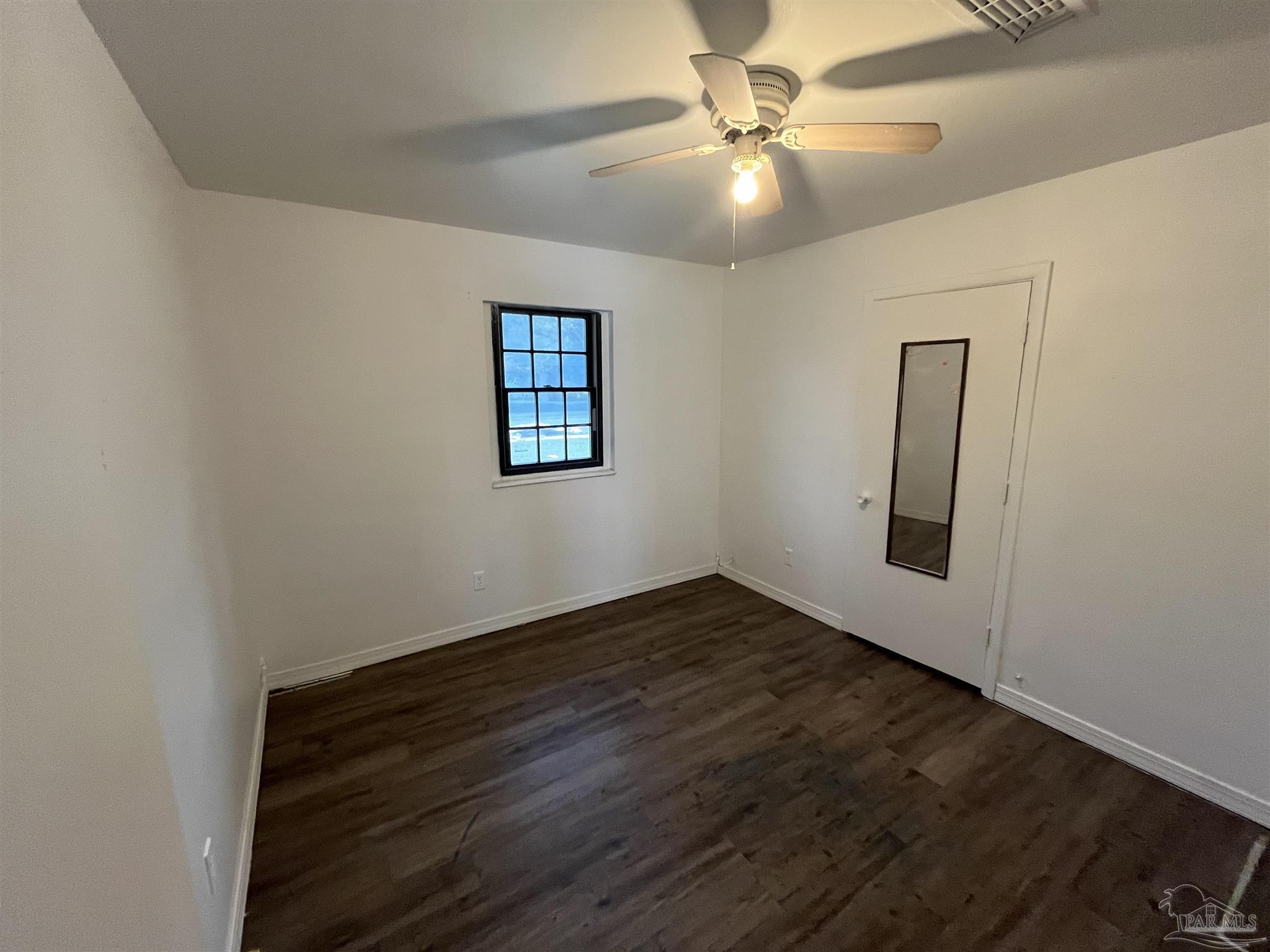 4511 St Nazaire Road Pensacola, FL 32505 - Photo 12 of 21 wooden floor in an empty room with a window