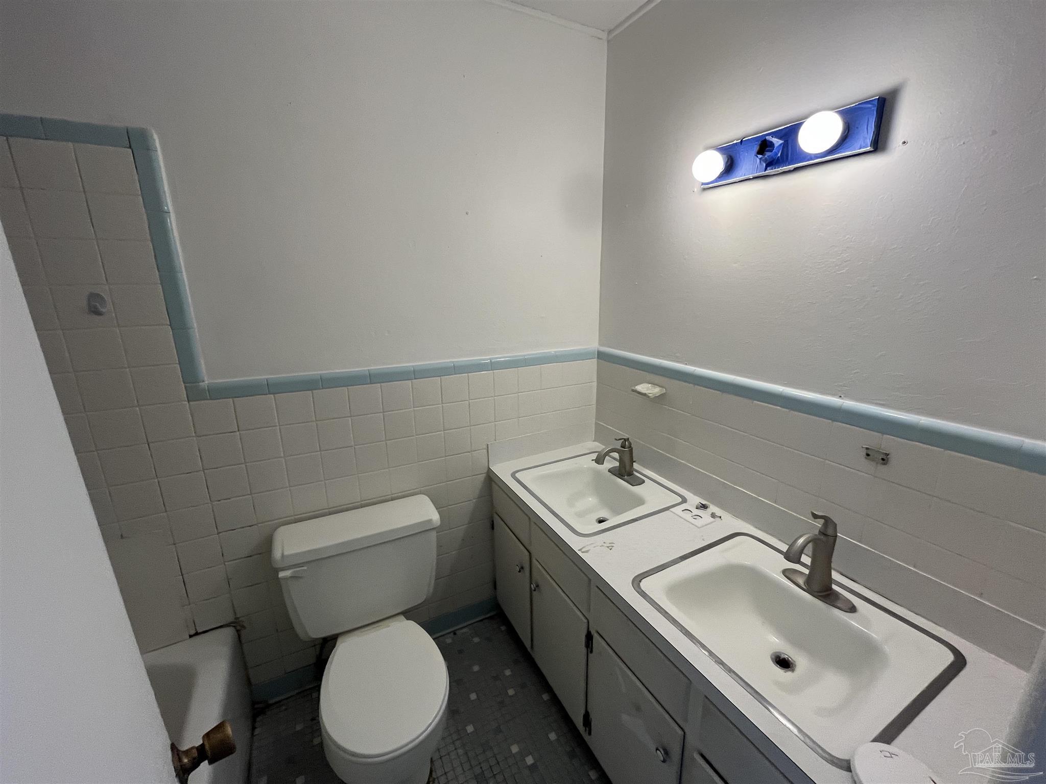 4511 St Nazaire Road Pensacola, FL 32505 - Photo 13 of 21 a bathroom with a toilet sink and mirror