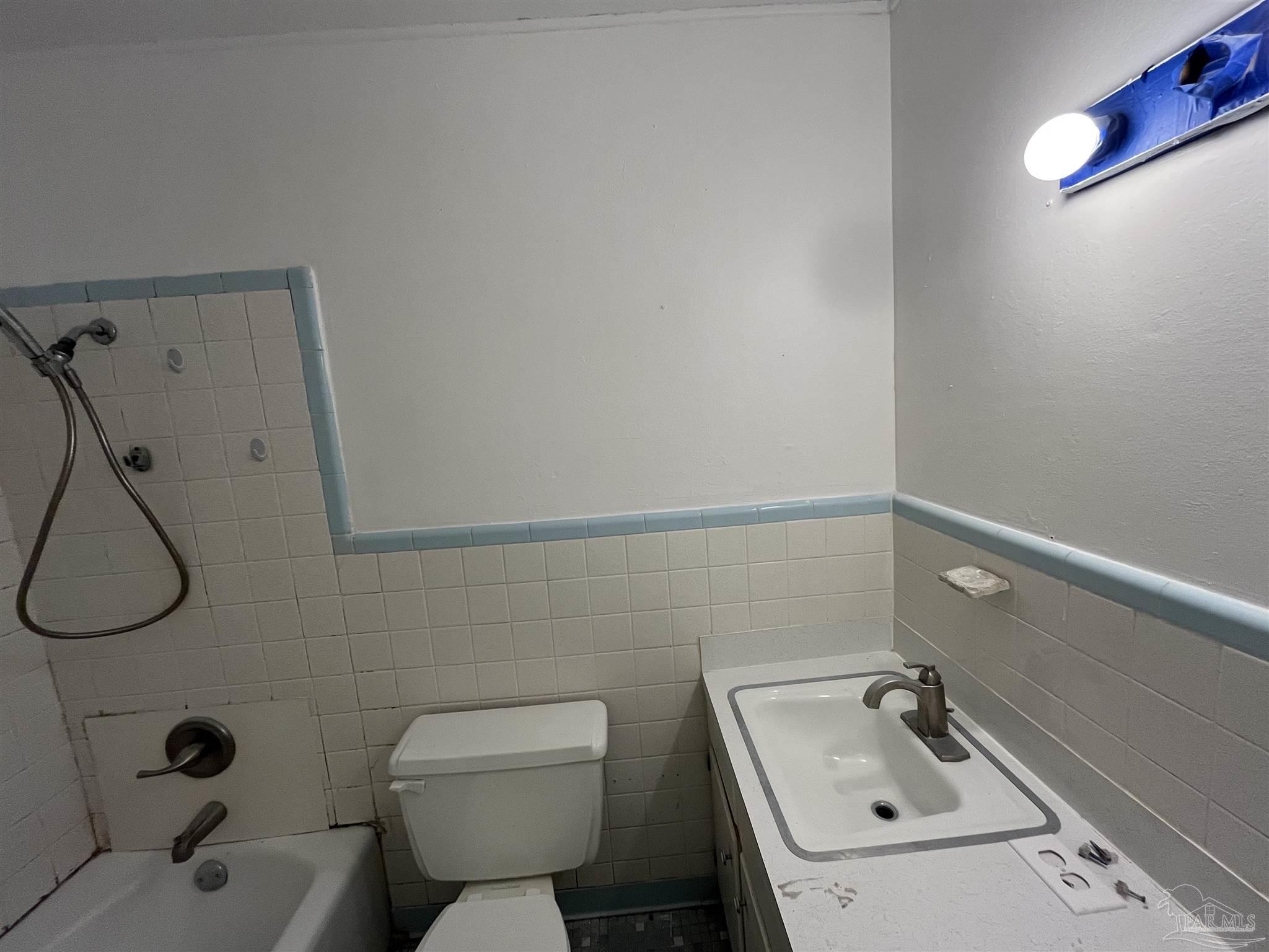 4511 St Nazaire Road Pensacola, FL 32505 - Photo 14 of 21 a bathroom with a sink toilet and shower