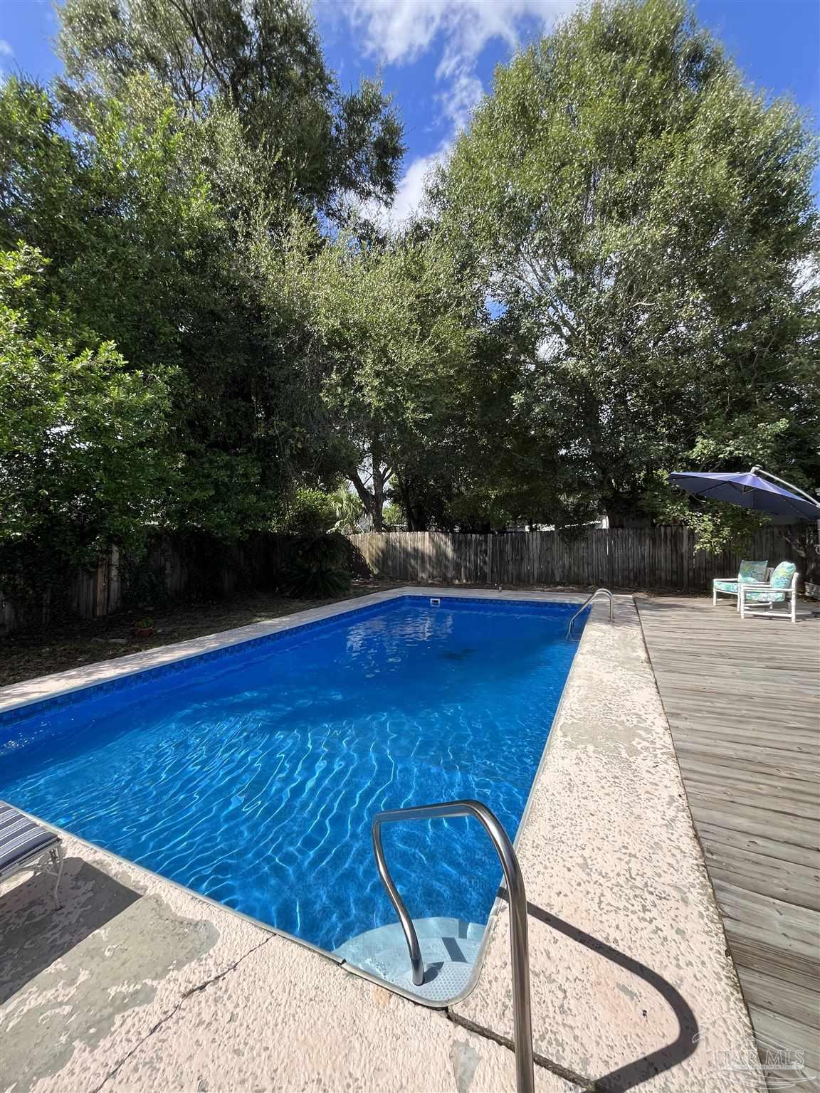 4511 St Nazaire Road Pensacola, FL 32505 - Photo 17 of 21 a view of outdoor space with swimming pool and trees