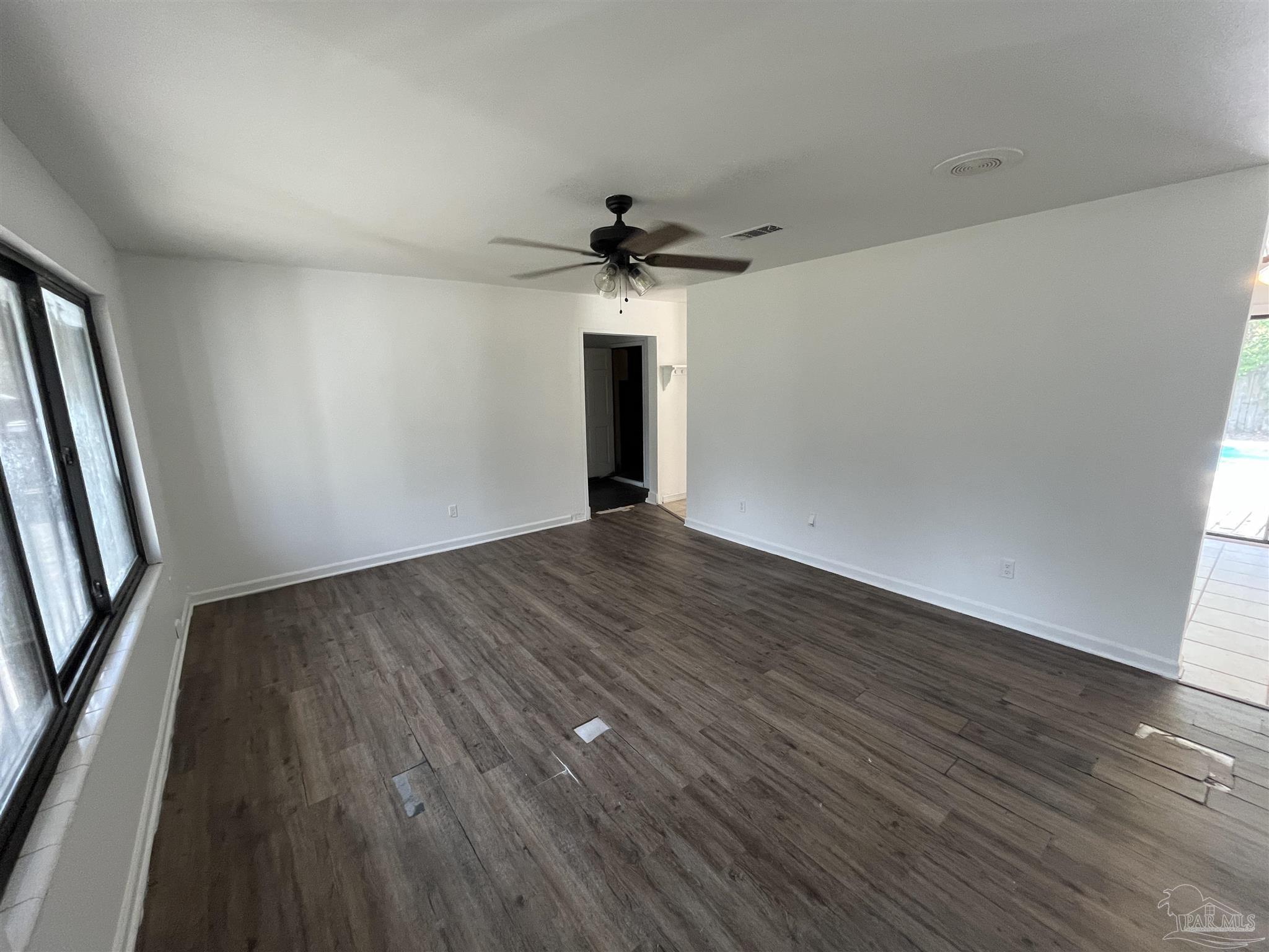 4511 St Nazaire Road Pensacola, FL 32505 - Photo 6 of 21 wooden floor in an empty room with a window