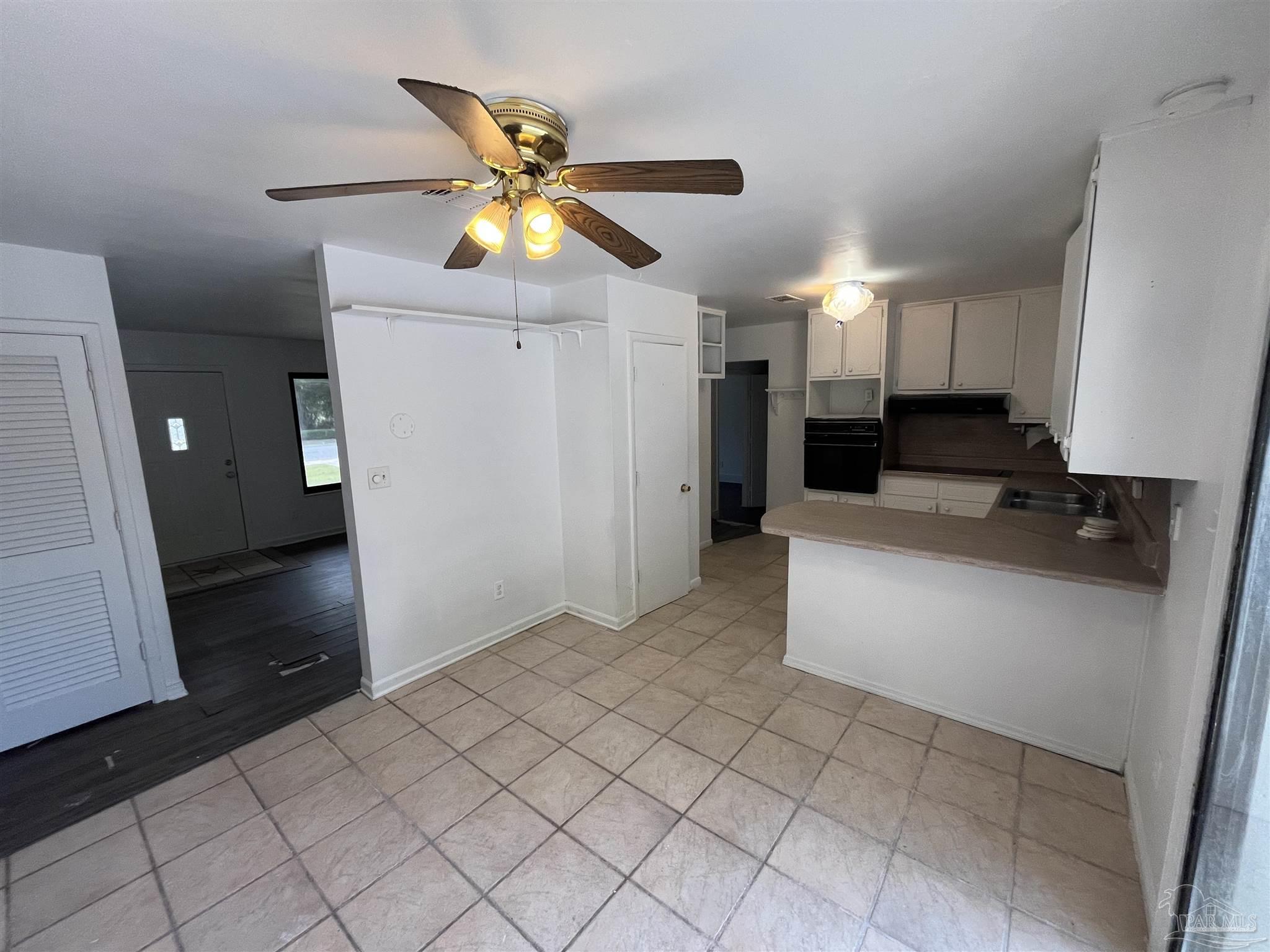 4511 St Nazaire Road Pensacola, FL 32505 - Photo 8 of 21 a kitchen with a refrigerator and a sink
