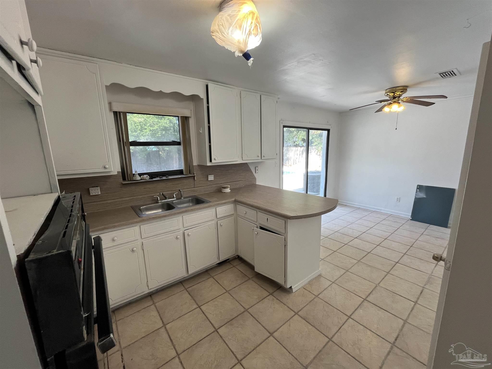 4511 St Nazaire Road Pensacola, FL 32505 - Photo 9 of 21 a kitchen with a sink cabinets and window
