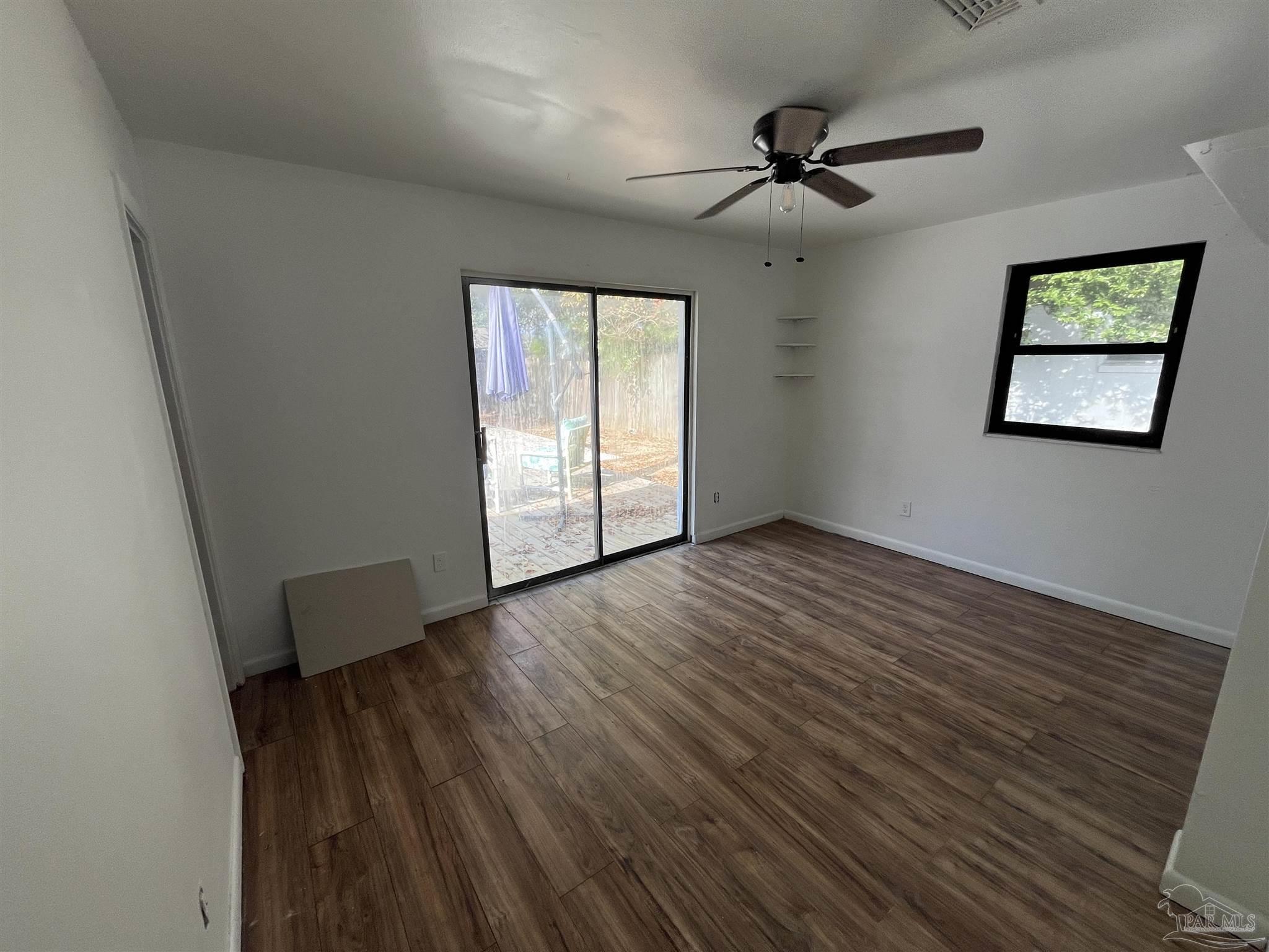 4511 St Nazaire Road Pensacola, FL 32505 - Photo 10 of 21 wooden floor in an empty room with a window