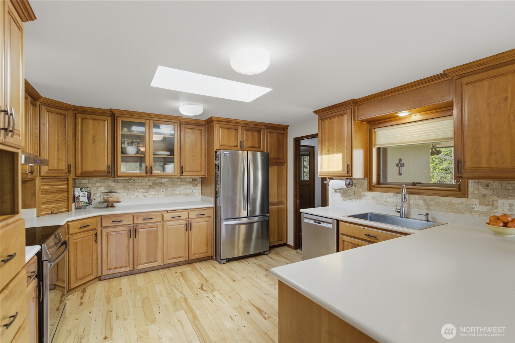 14608 A P Tubbs Road East Buckley, WA 98321 - Photo 12 of 39 a kitchen with stainless steel appliances granite countertop a sink refrigerator and cabinets