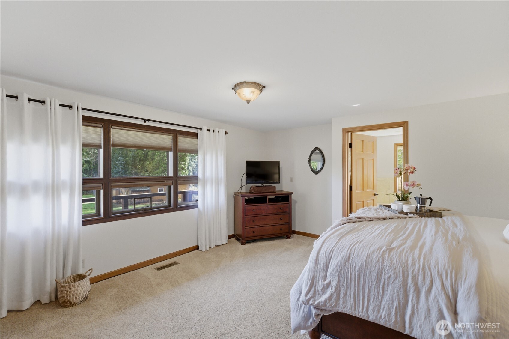 14608 A P Tubbs Road East Buckley, WA 98321 - Photo 14 of 39 a bedroom with a bed and a large window