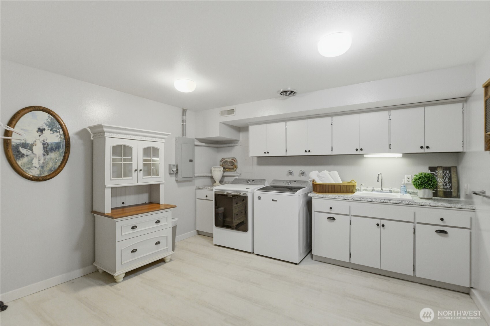 14608 A P Tubbs Road East Buckley, WA 98321 - Photo 23 of 39 a kitchen with cabinets and wooden floor