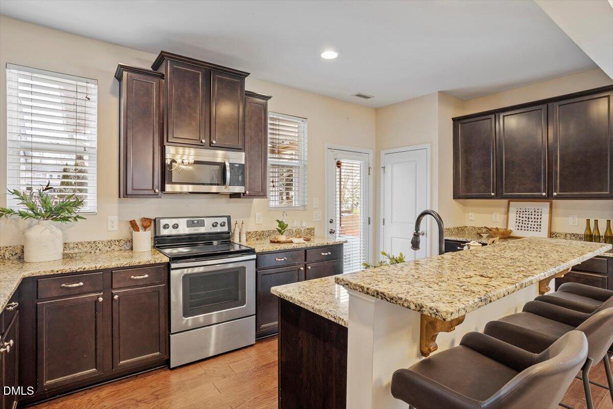 2105 Pear Tree Lane Durham, NC 27703 - Photo 10 of 35 a kitchen with a sink stove top oven and microwave