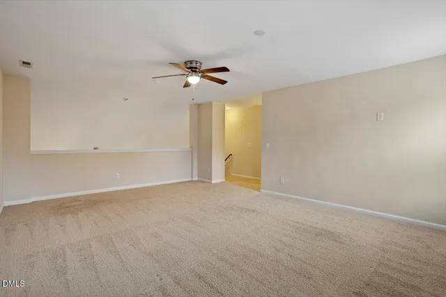 a view of an empty room with a fan