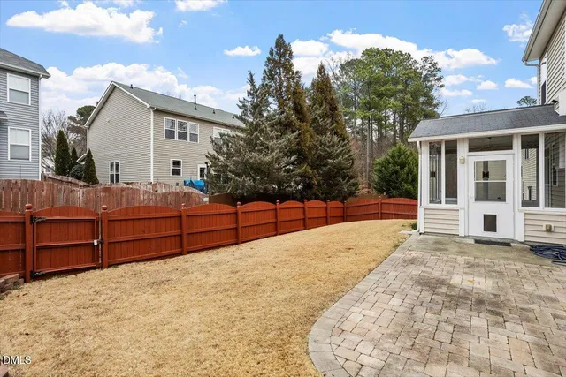 a view of backyard with a garden and trees