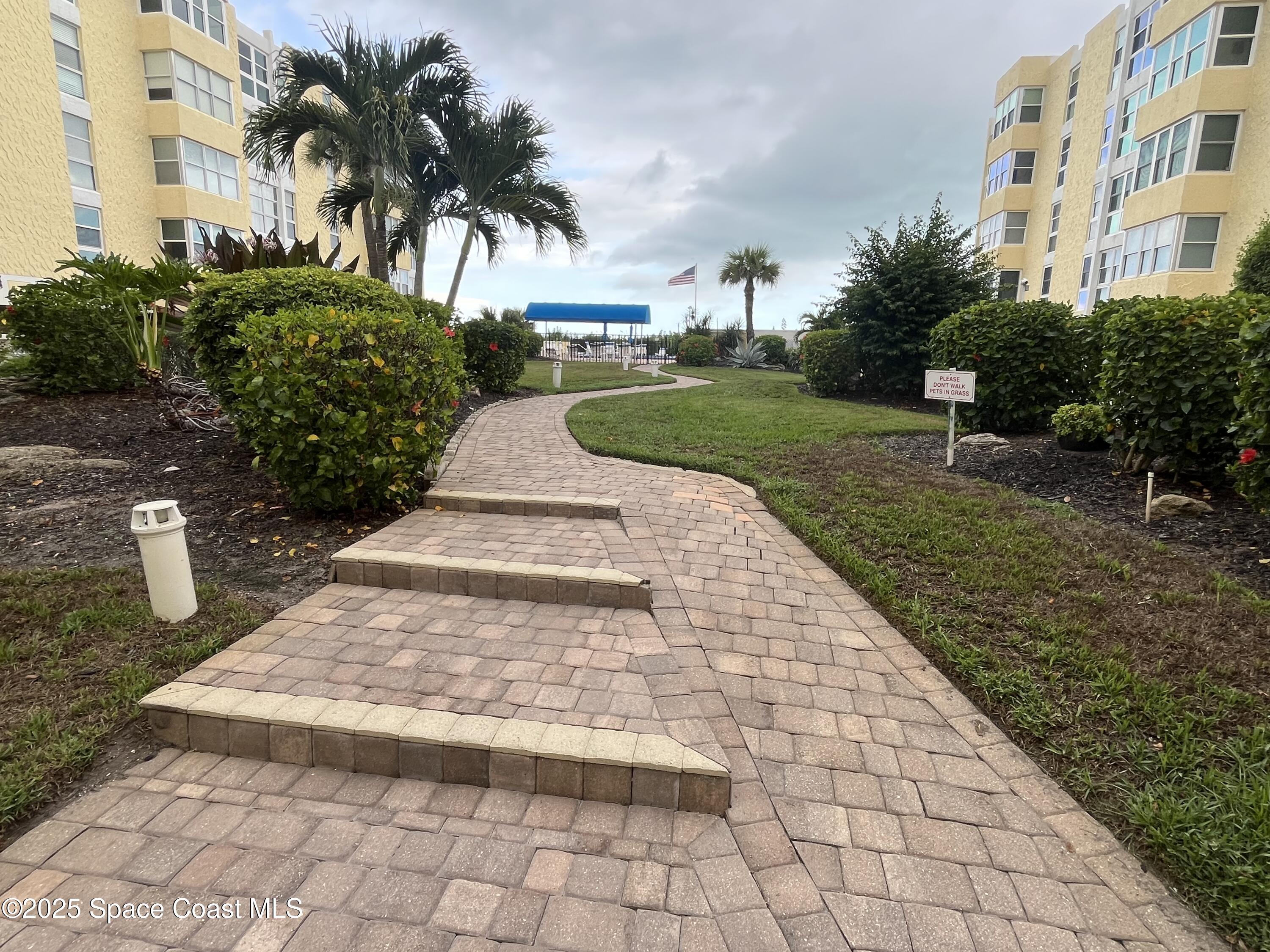 4700 Ocean Beach Boulevard, Unit 410 Cocoa Beach, FL 32931 - Photo 17 of 27 Walkway to Pool/Beach