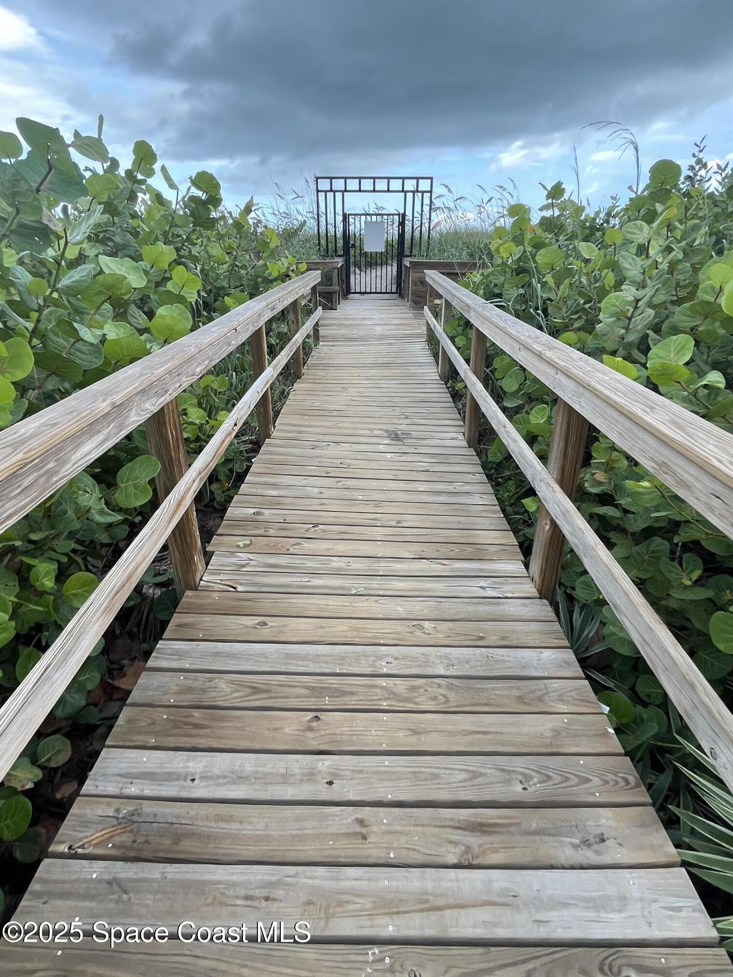 4700 Ocean Beach Boulevard, Unit 410 Cocoa Beach, FL 32931 - Photo 20 of 27 Walkway to Beach