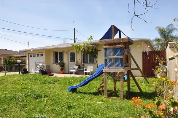 a view of a house with a yard and sitting area