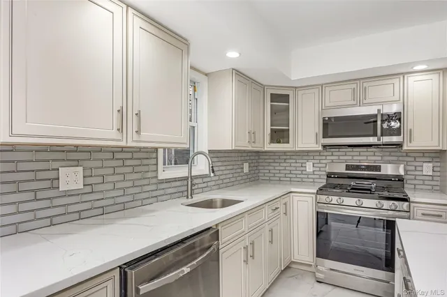 a spacious bathroom with a sink and a large mirror